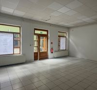 Commercial spaces with tiles and large windows, waiting to be utilized.