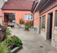 A family house on M. R. Štefánik Street in Holíč with a landscaped yard and flowers.