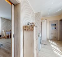 A kitchen and dining room in a family house with a wooden decor floor.