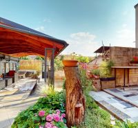 A garden with seating and a wooden shelter at a family house on M. R. Štefánika Street in Holíč.