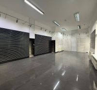 Commercial premises with a shiny floor, built-in lights, and slatted walls.