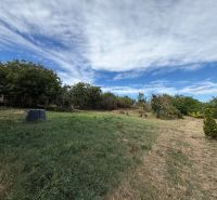 Plots - living in Krušovce with greenery and a vast grassy area under the blue sky.