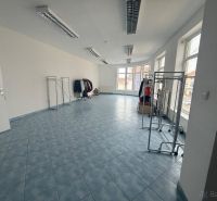 Retail spaces with blue tiles and clothing racks.