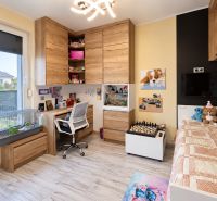 Children's room with wood-patterned flooring, a bed, and a desk in a family house.