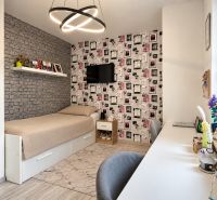 Children's room with brick cladding, a single bed, and a desk in a family house.