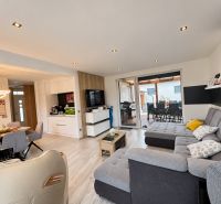 Living room of a family house with a comfortable sofa and open access to the terrace.