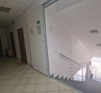 Interior of an office with a spacious staircase and tiles, in a quiet environment.
