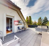 Terrace of a 2-room apartment in Miloslavov on Hlavná Street with seating and greenery.