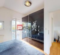 A bedroom with a wood-patterned floor and a built-in wardrobe in a 2-room apartment.