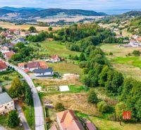 Hilly landscape surrounds the houses in Detva, ideal for residential plots.