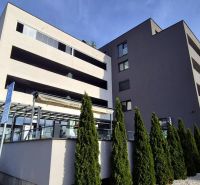 A building with a 2-room apartment on Javorova Street in Malacky surrounded by dense vegetation.