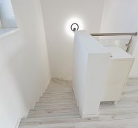 Staircase and floor with wooden decor in a 3-room apartment.