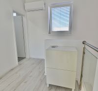A bright hallway in a 3-room apartment with air conditioning and a wooden decor floor.