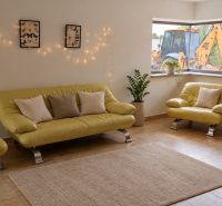 Living room in a family house with a leather sofa, decorations, and a view of an excavator.