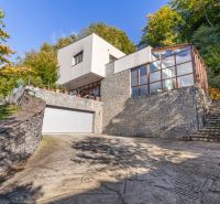 A family house on Karpatská Street in Marianka, surrounded by greenery with a glass terrace.