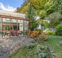 A family house on Karpatská Street in Marianka with a glazed winter garden and a landscaped garden.