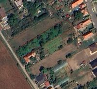 Residential plots in Jasová with marked area, surrounded by greenery and buildings.