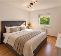 Bedroom in a family house with a large bed and a floor with a wooden decor.