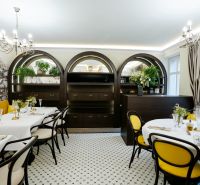 Stylish commercial spaces with elegant furniture, curved shelves, and yellow accents.