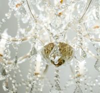 A luxurious chandelier with crystal drapes hangs in the commercial premises.