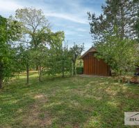 Garden with a lawn and a wooden structure on Hlavná Street in Štefanová.