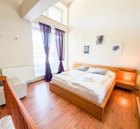 A bright bedroom with wood-patterned flooring in a 3-room apartment, pleasant atmosphere.