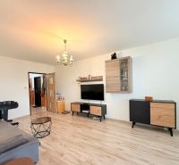 Living room in a 3-room apartment with a wooden decor floor and furniture.