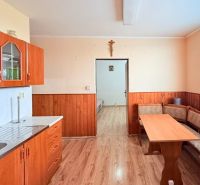A kitchen in a 3-room apartment with a kitchen unit and a dining table.