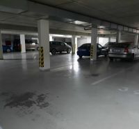 Underground garage parking space with parked cars in a 2-room apartment.