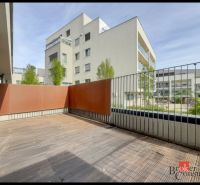 Terrace of a 2-room apartment with a wooden decor floor, surrounding apartment buildings, Svätovavrinecká, Bratislava-Nové Mesto.
