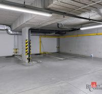 A parking space in an underground garage on a color-marked floor.