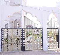 Entrance gate at a 2-room apartment on Mbweni Street in Zanzibar with decorative metal elements.