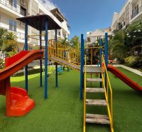 Playground on Mbweni Street in Zanzibar with climbing frames and slides.