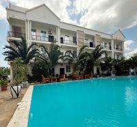 A building by the pool and palm trees in the Mbweni area of Zanzibar.