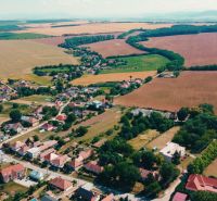Aerial view of plots - housing in Čermany surrounded by vast fields and greenery.