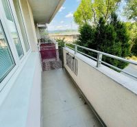 The balcony of a 1-room apartment on Tomášikova Street in Bratislava - Nové Mesto with a view of greenery.