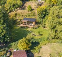 A wooden house in the forest among recreational plots in Štiavnické Bane.