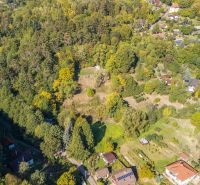 Aerial view of Recreational plots in Štiavnické Bane surrounded by forest and nature.
