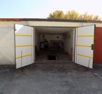 An open garage on Petőfi Row in Štúrovo with a pit and stored items.