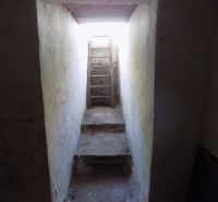 Narrow stairs in the garages leading to the light through a narrow passage.
