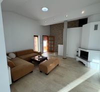 Living room in a family house with a fireplace and a spacious sofa set.