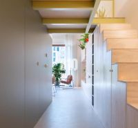 A cozy hallway with storage space and a staircase in a 2-room apartment.