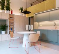Compact kitchen and dining area with a round table in a 2-room apartment.