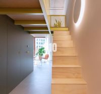 The staircase leads to the upper floor of a two-room apartment with a bright interior.