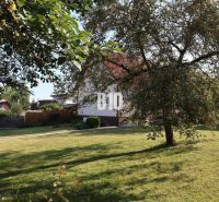 A family house in Žilina with a large garden, lawn, and fruit trees.