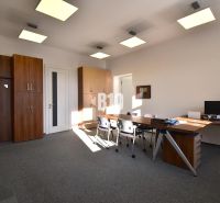 Offices with desks, chairs, and built-in wardrobes, illuminated by light fixtures.