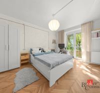 A bedroom with a bed, furniture, and flooring with a wood decor in a 2-room apartment.