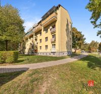 Apartment building on Hubeného Street in Bratislava-Rača surrounded by greenery and a road.