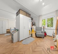 Children's room in a two-room apartment with an open space and a wooden decor floor.