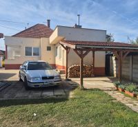 Family house in Ludanice, car in the yard, wood under the shelter, garden.